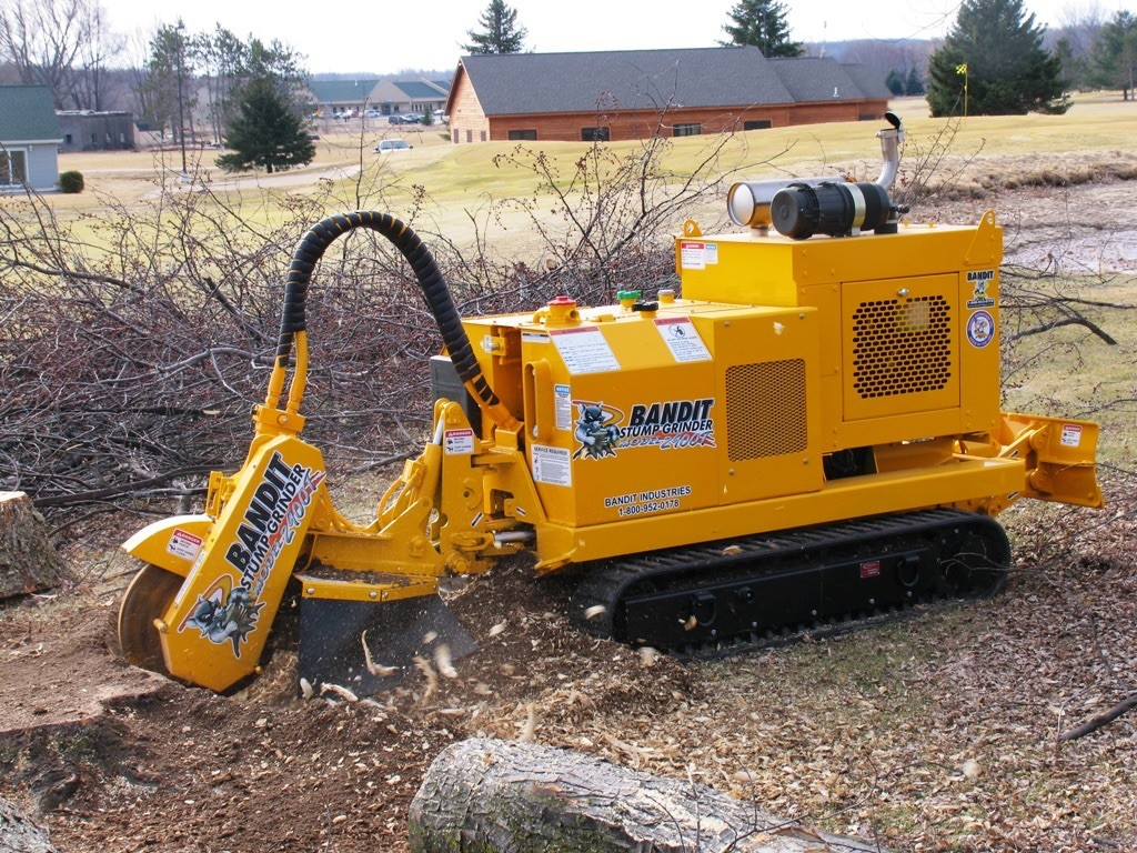 Stump grinder removing a tree stump in a Spanish Fort, AL yard